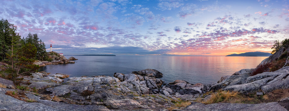 panoramic view of a lighthouse park on a rocky coast during a dramatic cloudy sunset. horseshoe bay,