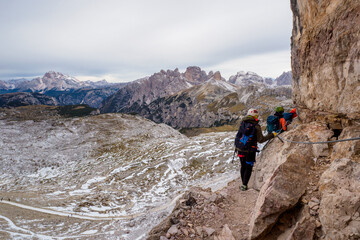 Wall Mural - People climbing on a via ferrata route in the mountains. Adventure mountain activity. National Park Tre Cime di Lavaredo, Dolomiti Alps, South Tyrol, Italy