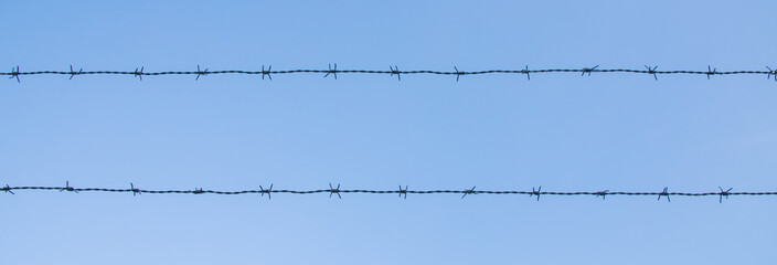 barbed wire on blue sky background