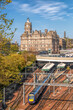 Edinburgh Waverley railway station with trains against Clock Tower building in Scotland, United Kingdom