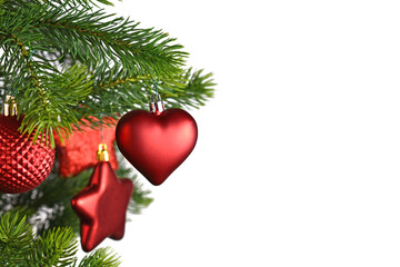 Wall Mural - Red heart shaped Christmas bauble on decorated Christmas tree on side of white background with copy space