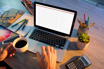 hands of caucasian male programmer sitting at desk with coffee, using laptop with coding on screen