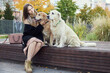 © snedorez - beautiful girl hugs two golden retrievers. Outdoor