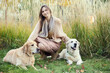© snedorez - Beautiful girl with two golden retrievers in park