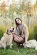 © snedorez - Beautiful girl with two golden retrievers in park
