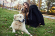 © snedorez - Beautiful girl with two golden retrievers in park