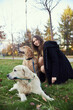 © snedorez - Beautiful girl with two golden retrievers in park