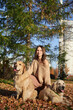 © snedorez - Beautiful girl with two golden retrievers in park