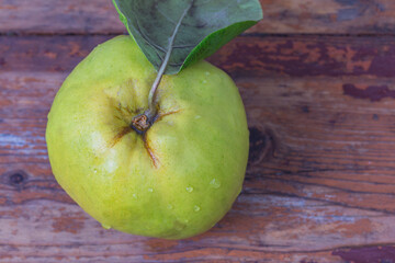 Wall Mural - ripe fresh quince close up on wood board