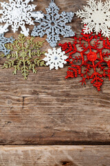 Border from snowflakes on an old wooden background.