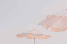 White Beach Patio Sun Umbrellas Above White Sky. Neutral Color.