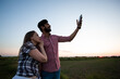 © oksix - Young girl taking selfie in summer wheat field