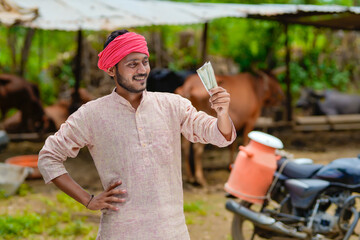 Canvas Print - Rural scene : Indian milkman counting and showing money