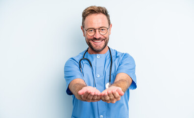 middle age handsome man smiling happily with friendly and  offering and showing a concept. nurse concept