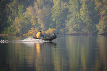 Rubber Inflatable Motor Boat On The River With Fisherman
