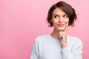 Poster - Photo of cheerful minded young positive woman dream look empty space hand chin isolated on pink color background