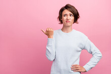 Photo Of Unhappy Upset Doubtful Young Woman Point Finger Empty Space Thumb Dislike Isolated On Pink Color Background