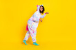 © deagreez - Full length body size view of attractive cheerful girl wearing pajama walking fooling isolated over bright yellow color background