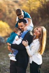 Wall Mural - Young family with two sons together outside the park