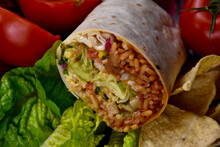 Burrito Wrap With Vegetable Close-up Stock Images. Traditional Mexican Food Images. Vegetarian Bean And Rice Burrito Still Life Stock Photo