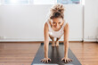 © Austockphoto - Bright pilates studio with girl doing a plank