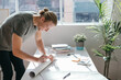 © Austockphoto - Creative guy addressing a mailing tube to send by post
