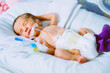 Portrait of a newborn baby sleeping inside an incubator