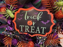 Festive Trick Or Treat Halloween Sign Is Displayed Surrounded By Halloween Themed Decorations