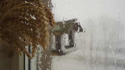 Wall Mural - Heavy snowfall behind the window. Slow motion. Raindrops running down a window. 