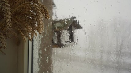 Wall Mural - Heavy snowfall behind the window. Slow motion. Raindrops running down a window. 