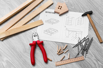 Wall Mural - Furniture assembling instructions, wooden house and different tools on grey wooden background