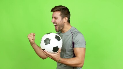 Wall Mural - Handsome man playing futbol and celebrating a victory over isolated background