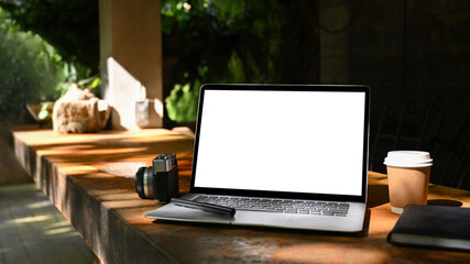 Poster - Mock up laptop computer with empty screen, coffee cup and camera on wooden table.