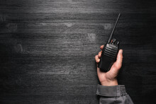 A Worker With A Walkie Talkie Radio Station In The Hand On The Black Flat Lay Background With Copy Space.
