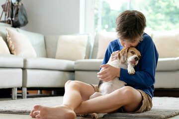 Wall Mural - Child Playing With His Pet Dog At Home