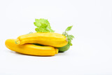 Fototapeta Kuchnia - Yellow zucchinis, squash with green leaf on a white background