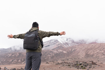 Poster - Young man in the mountains, enjoying the fresh air and beautiful view.