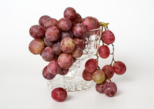 A Handful Of Grapes In A Glass Cup