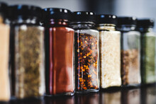 Spices Seeds And Seasonings In Mathing Spice Jars On Tidy Pantry Shelf, Simple Vegan Ingredients And Flavoring Your Dishes