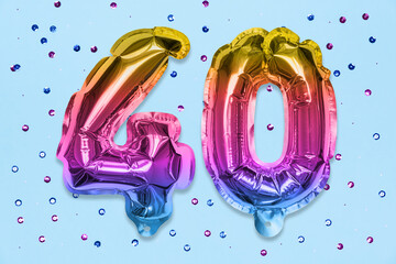 Wall Mural - Rainbow foil balloon number, digit forty on a blue background with sequins. Birthday greeting card with inscription 40. Anniversary concept. Top view. Numerical digit. Celebration event, template.