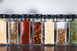 © faithie - spices seeds and seasonings in mathing spice jars on tidy pantry shelf, simple vegan ingredients and flavoring your dishes