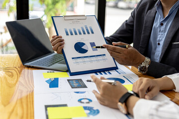 Executives and managers are meeting in a conference room, on the table there are some documents about the company's finances, managers are discussing financial information with the management.