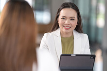 College Instructors And Advisors Meet Female College Students To Advise Their Research Study. Education Concept Stock Photo