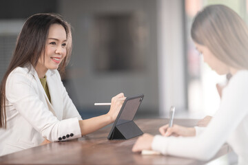 College instructors and advisors meet female college students to advise their research study. Education Concept Stock Photo