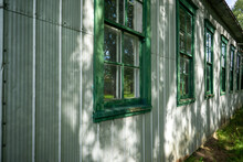 Wall Of A Village House With Green Window Frames