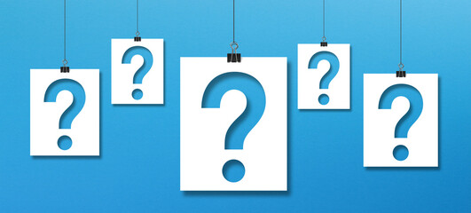 Wall Mural - Question mark on paper hanging with clip on blue background