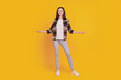 © Tetiana - Photo of positive promoter lady hands demonstrate empty space compare options isolated on yellow color background