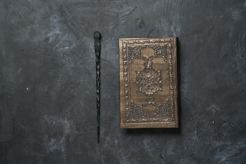 Wall Mural - Subjects of the school of magic. Book of spells on dark grey background.