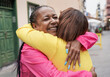 © Sabrina - Mature multiracial women meeting each other and hugging together in the city