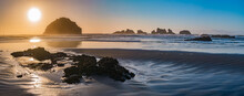 Pacific Ocean Sunset View Of Face Rock In Bandon Oregon With Setting Sun Creating A Star.